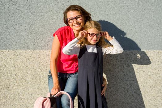 Portrait of a Mom and Daughter of a Small Schoolgirl with Glasses