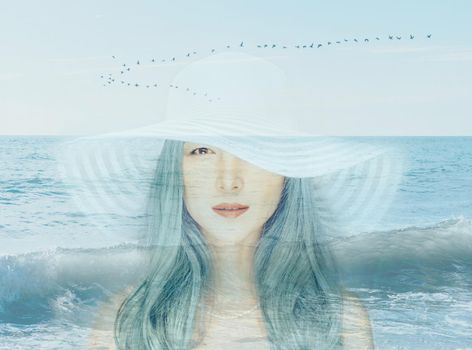 Double exposure portrait of beautiful young woman with blue hair combined with image of seascape.