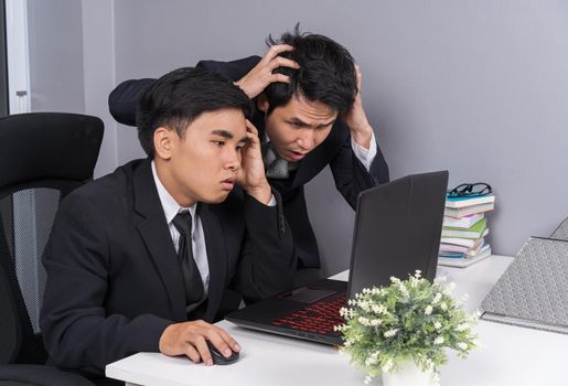 serious stressed two business man using laptop computer to working project