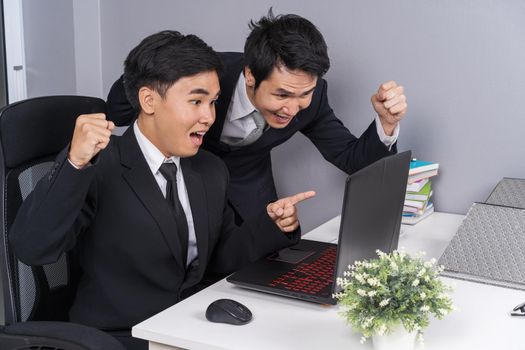 happy two business man using laptop computer to  successful working project