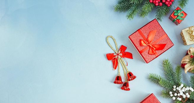 Frame of twigs christmas tree, brown natural pine cones and red berries on snow with space for text. Top view, flat lay