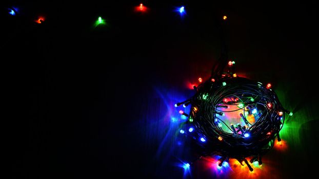 Christmas lights. Beautiful colorful abstract background with Christmas tree decorations. Concept for winter and holidays. 
Flat lay - copy space.