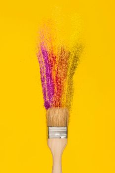 Pain brush and stroke or smear made of glossy sparkling glitter on bright yellow background. Vertical banner. Creative art concept