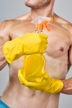 funny pumped up man rubber gloves detergents service. High quality photo