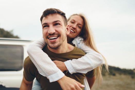 Young couple is on romantic trip to the mountains by car, close up