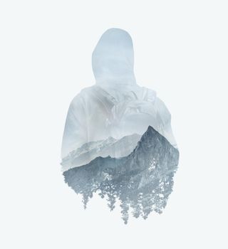 Double exposure image of male backpacker and mountains.