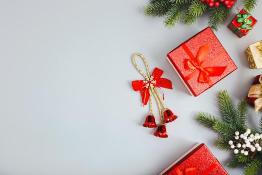 Frame of twigs christmas tree, brown natural pine cones and red berries on snow with space for text. Top view, flat lay