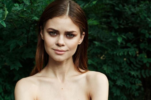 portrait of a woman in a field outdoors bare shoulders clear skin cropped view. High quality photo