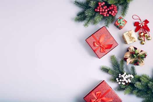 Frame of twigs christmas tree, brown natural pine cones and red berries on snow with space for text. Top view, flat lay