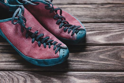 Shoes for climbing sport on a wooden background.