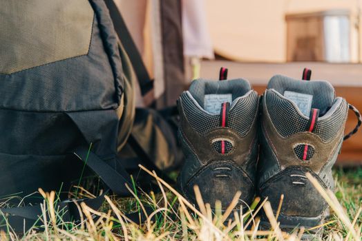 Trekking boots near the backpack outdoor.