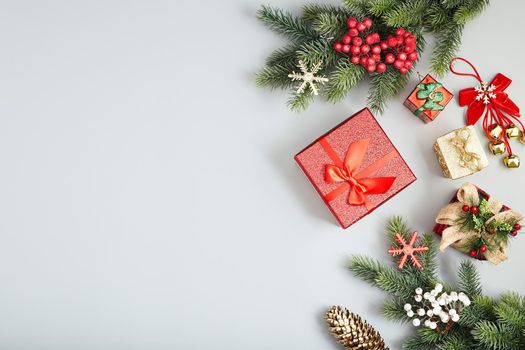 Frame of twigs christmas tree, brown natural pine cones and red berries on snow with space for text. Top view, flat lay