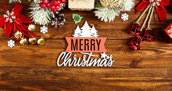 Christmas wooden background with snow fir tree. View with copy space . Copy space framed by Christmas tree branches, decorations, sweets.