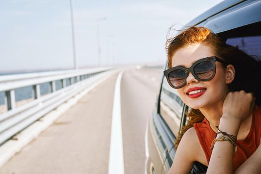 pretty woman in sunglasses rides in a travel car. High quality photo