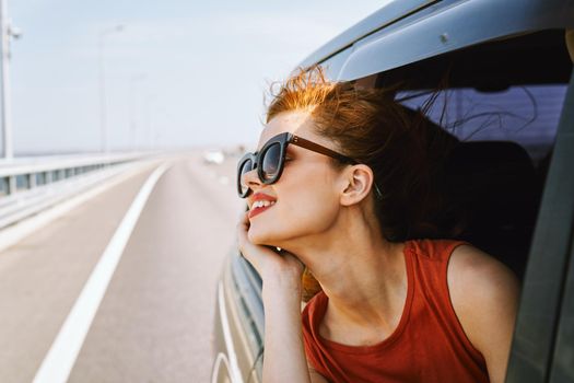 pretty woman in sunglasses rides in a travel car. High quality photo