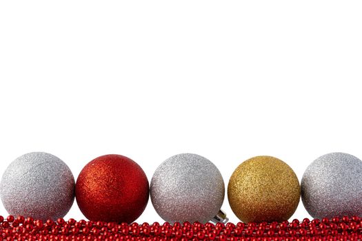 Pile of Christmas baubles isolated on white background, close up