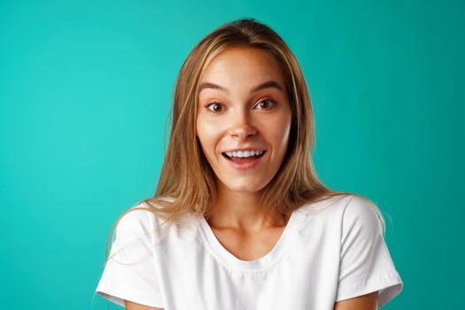 Shocked and amazed young blonde attractive woman close up portrait