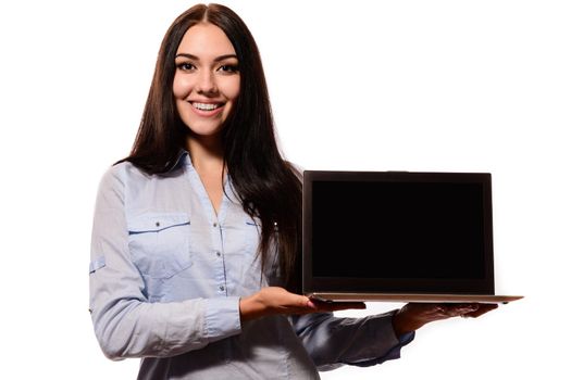 Smiling woman showing a blank laptop screen with copyspace for your advertising