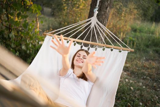 woman relaxing in nature in a hammock garden fresh air. High quality photo