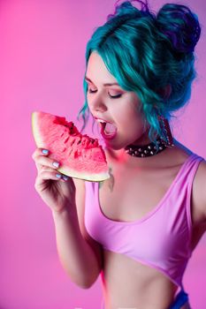 the portrait of a bright woman with blue hair eating a watermelon in neon light