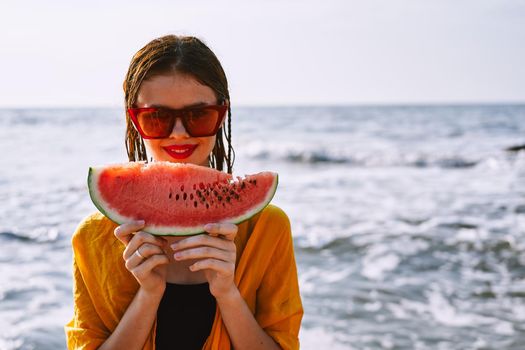 woman in swimsuit with watermelon outdoors sun fresh air. High quality photo