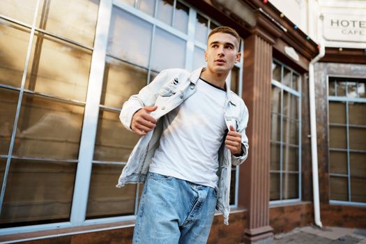 Portrait of handsome young casual man walking on the city street