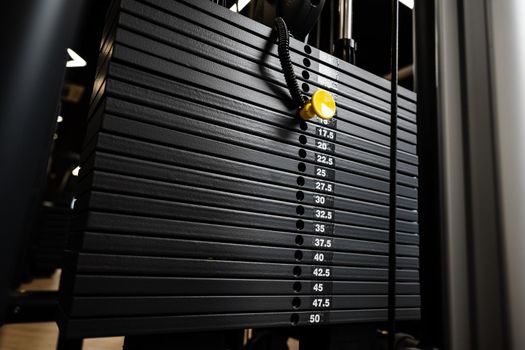 Stacked iron plates of weight machine in a gym