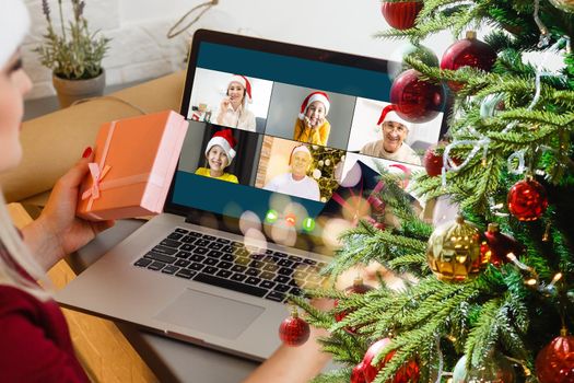 Attractive happy young girl student having video chat, waving. christmas.