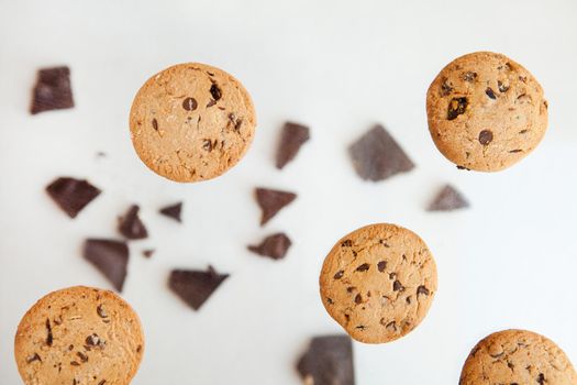 Homemade bakery and dessert. chocolate cookies flying - Chocolate chip cookie with crumbs on gray background.