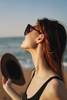cheerful woman in sunglasses Sandy coast landscape sun. High quality photo