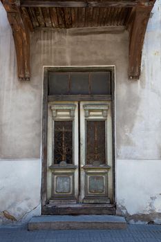 Wooden door with decoration elements in old building facade. Tallinn, Estonia. Colorful timber antique door