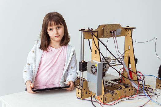 Cute girl with 3d printed shutter shades is watching her 3d printer as it prints her 3d model