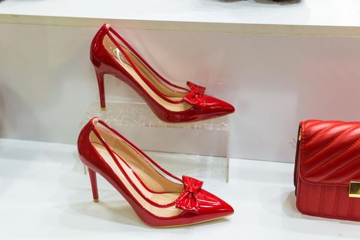 Women's shoes at the shop, red shoes for lady. Fashion, shopping and retail.