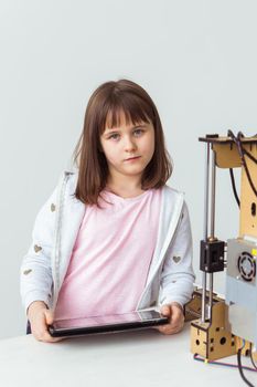 Child student makes the item on the 3D printer. School, technologies and science.