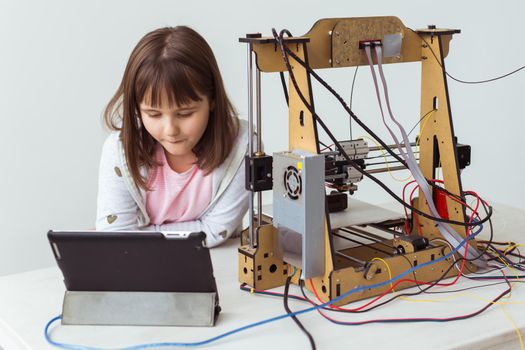 Little child architect using 3D Printer. Schoolgirl, technologies and study.