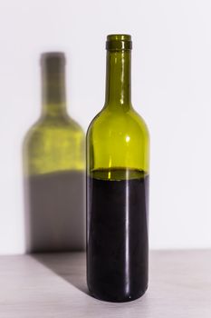 Shadow of wine glass in dark yellow light