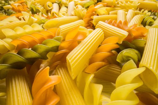 Variety of types and shapes of dry Italian pasta closeup. Food and traditional cuisine.