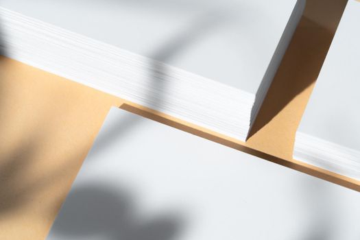 Creative photo with floral shadow of white businesscard on beige background, copy space
