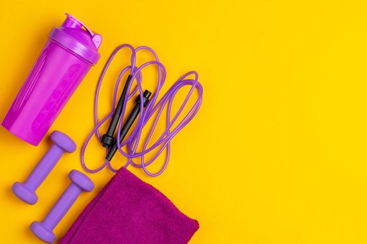 Assortment of sport equipment on yellow background, top view. Close up.