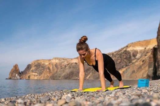 Group of young womans fitness instructor in Sportswear Leggings and Tops, stretching in the gym before pilates, on a yoga mat near the large window on a sunny day, female fitness yoga routine concept.