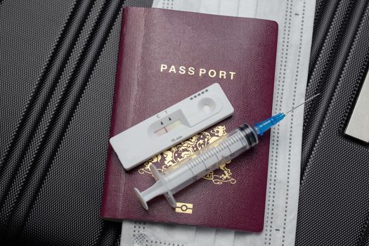 COVID-19, travel and lockdown concept,Passport with Covid-19 rapid test and syringe for vaccination Coronavirus. Traveling requirement flying holiday