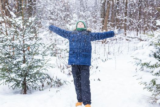 Happy boy throwing snow. Child, season and winter concept