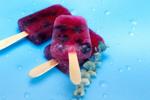 Homemade Raspberry and blueberry ice cream top view on blue background summer, desser,food concept modern design with copy space colorful ice style