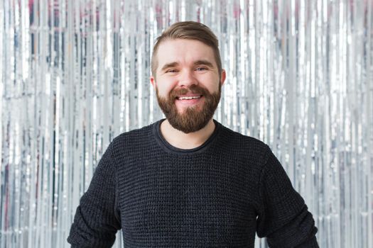 Cheerful guy smiled happily, has excited expression over shiny studio background. Holidays, youth, emotions.