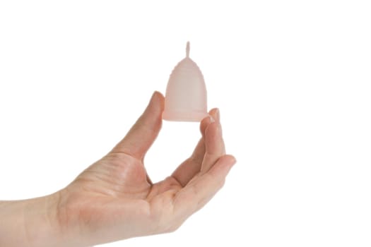 Womans hand holding menstrual cup, period cup isolated on white background with copy space, alternative product zero waste eco friendly closeup