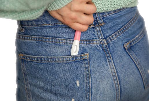 Young woman and pregnancy test with blank copy space for positive or negative result composite isolated on white background, Pregnancy test in jeans pocket closeup