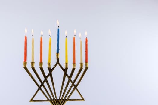 Candles for holiday lit for night of hanukkah menorah burning white background