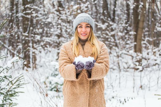 Close up of woman holding the snowball in hands, winter concept with copy space