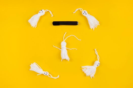 Halloween DIY concept. Make a cute garland of ghosts out of Knitting. Step 4