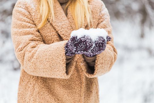 Close up of woman holding the snowball in hands, winter concept with copy space